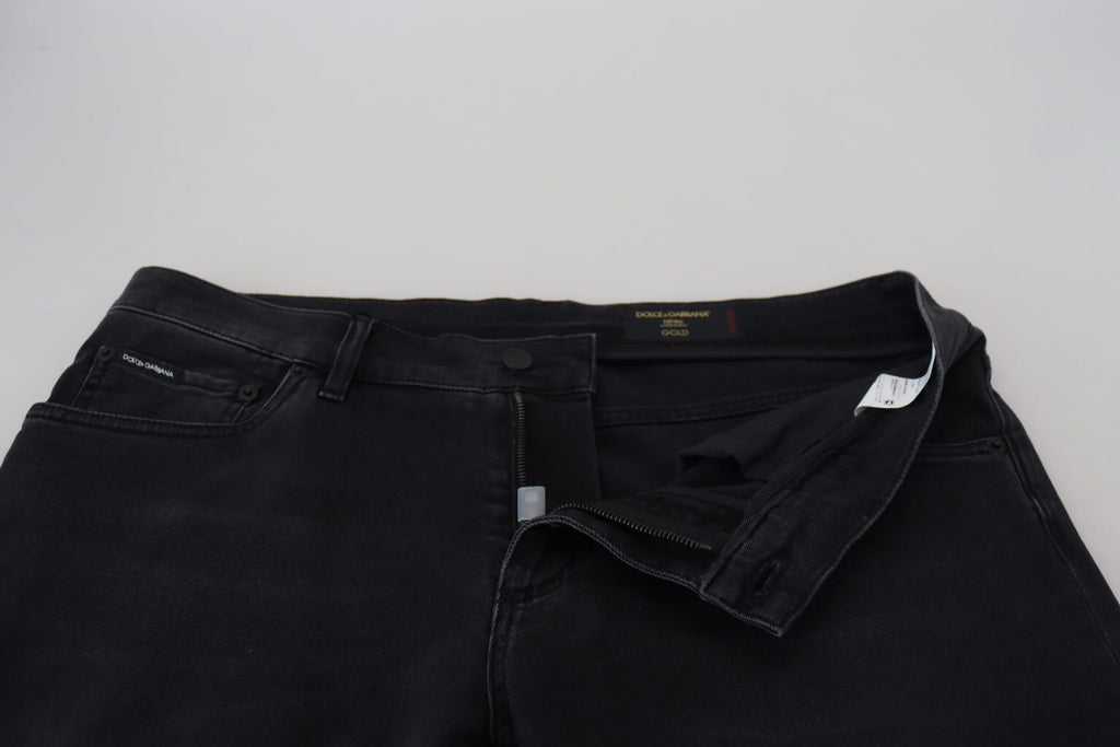 Jeans slim en denim noir Dolce & Gabbana avec broderie d'ange, coupe ajustée et détails élégants.