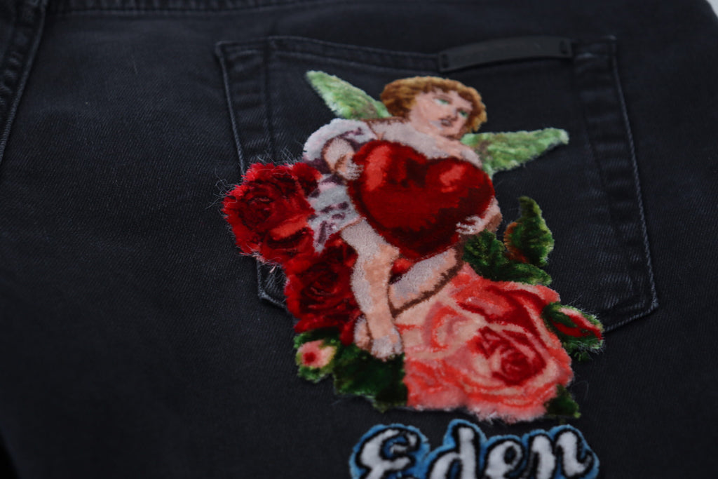 Jeans skinny en denim noir Dolce & Gabbana avec broderie d'ange, mode élégante et tendance pour femme.