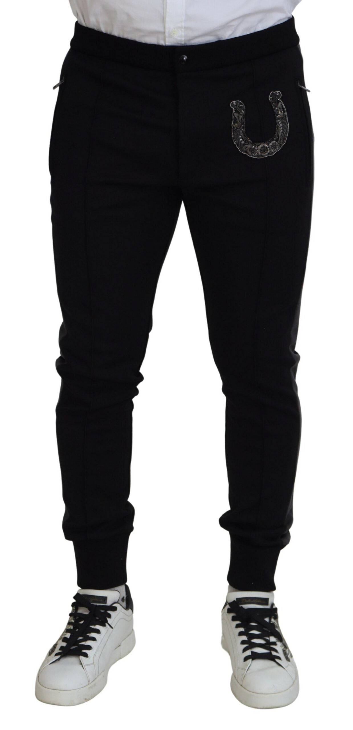 Pantalons joggers en laine noire Dolce & Gabbana avec motif de fer à cheval, style décontracté et élégant.