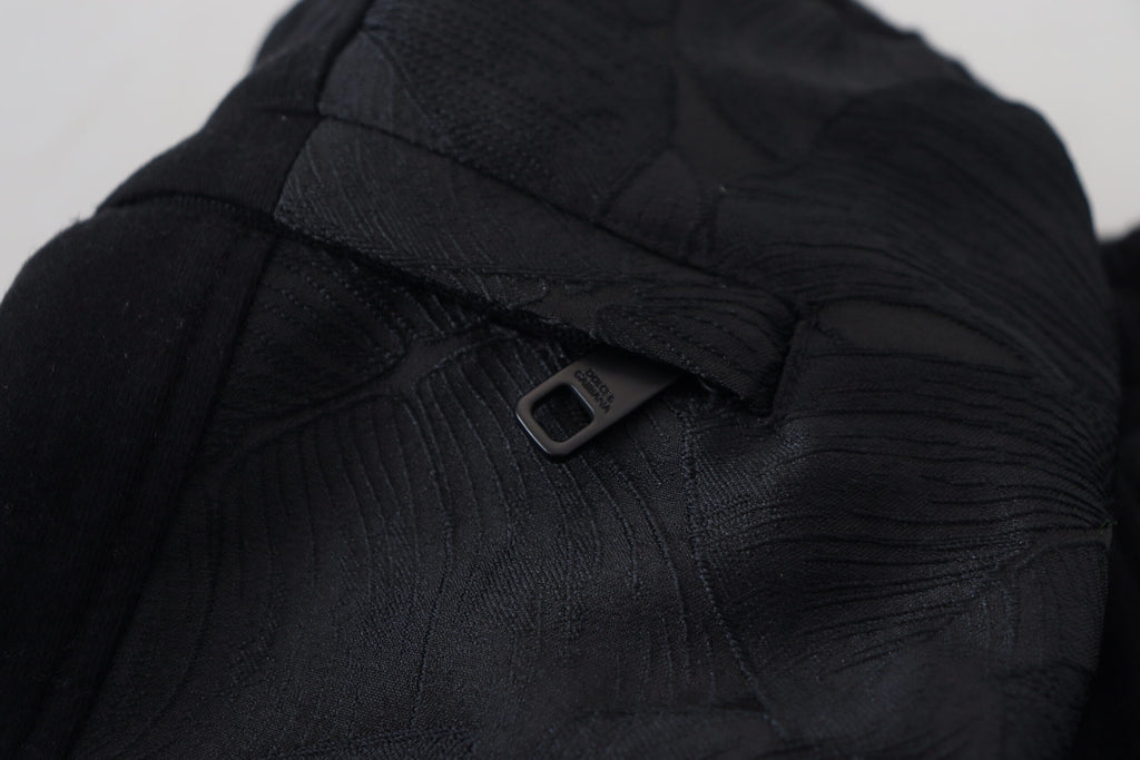 Pantalon homme Dolce & Gabbana en polyester noir, coupe skinny jogger avec ceinture élastique et poches latérales.