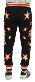 Pantalons de sport noirs et orange à étoiles de Dolce & Gabbana, matière confortable, style décontracté et élégant.