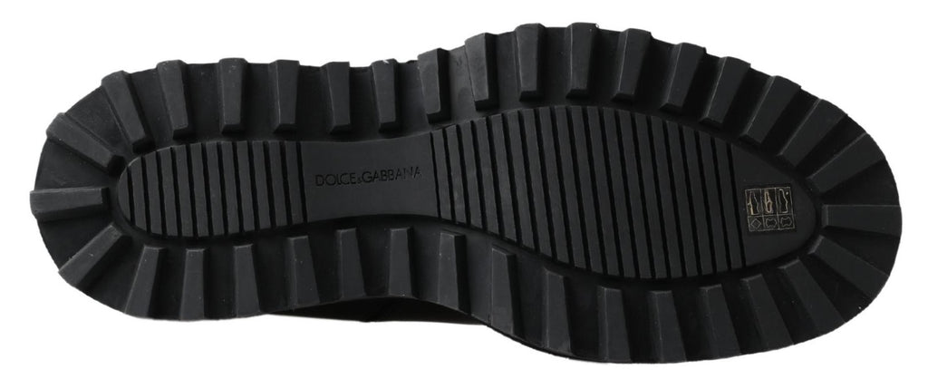Bottes noires en cuir stretch à enfiler de Dolce & Gabbana, style élégant et moderne, visibles dans l'image.