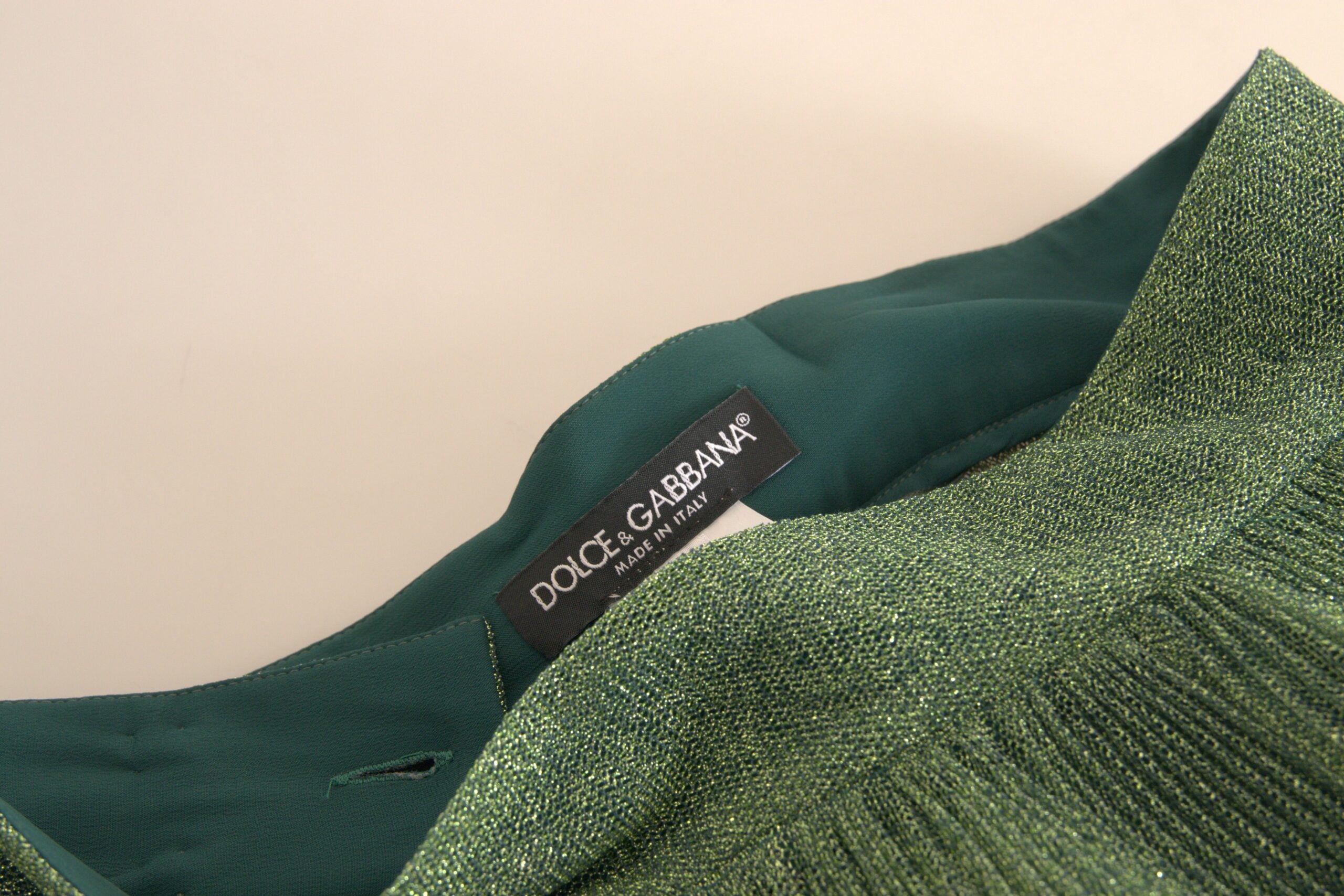 JUPE plissée verte métallisée à taille haute de Dolce & Gabbana, coupe A-line, élégante et sophistiquée.