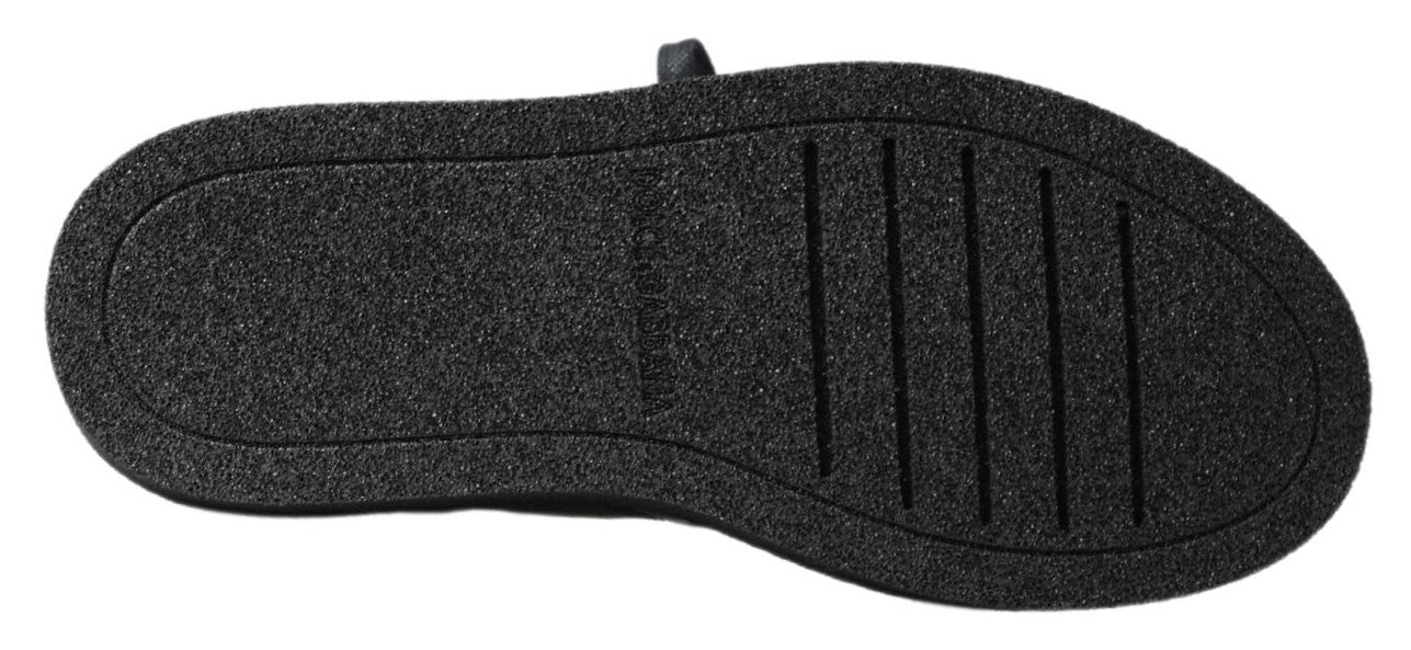 Bottes noires en cuir extensible Dolce & Gabbana, style slip-on, avec finition élégante et semelle robuste.