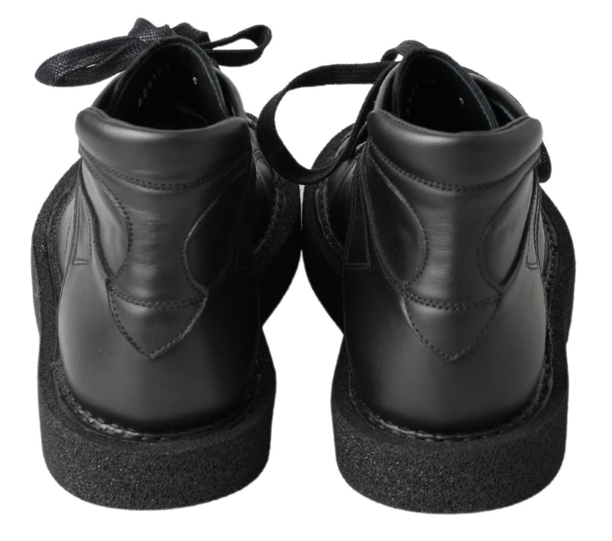 Bottes noires en cuir extensible Dolce & Gabbana, style slip-on, avec finition élégante et semelle en caoutchouc.