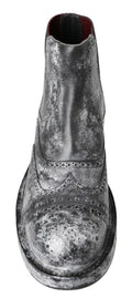 Bottes ankle en cuir noir et gris de Dolce & Gabbana, élégantes et sophistiquées, visibles avec détails en cuir.