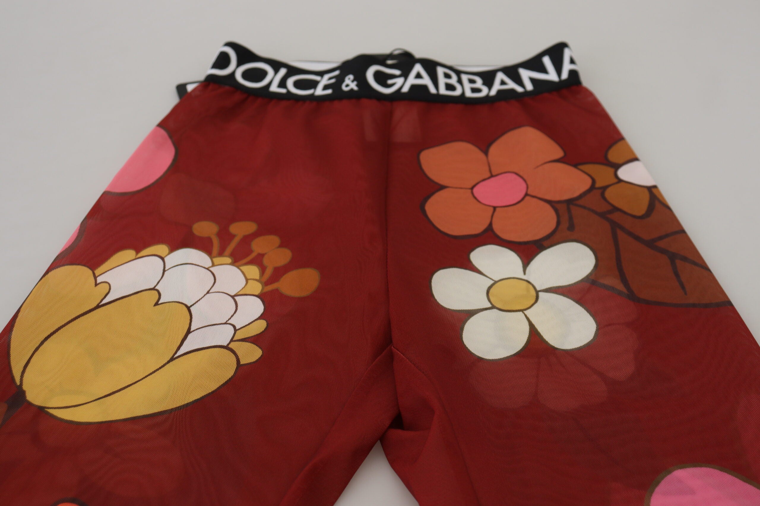 Leggings fleuries rouges Dolce & Gabbana avec taille extensible et coupe ajustée, en tissu stretch élégant.