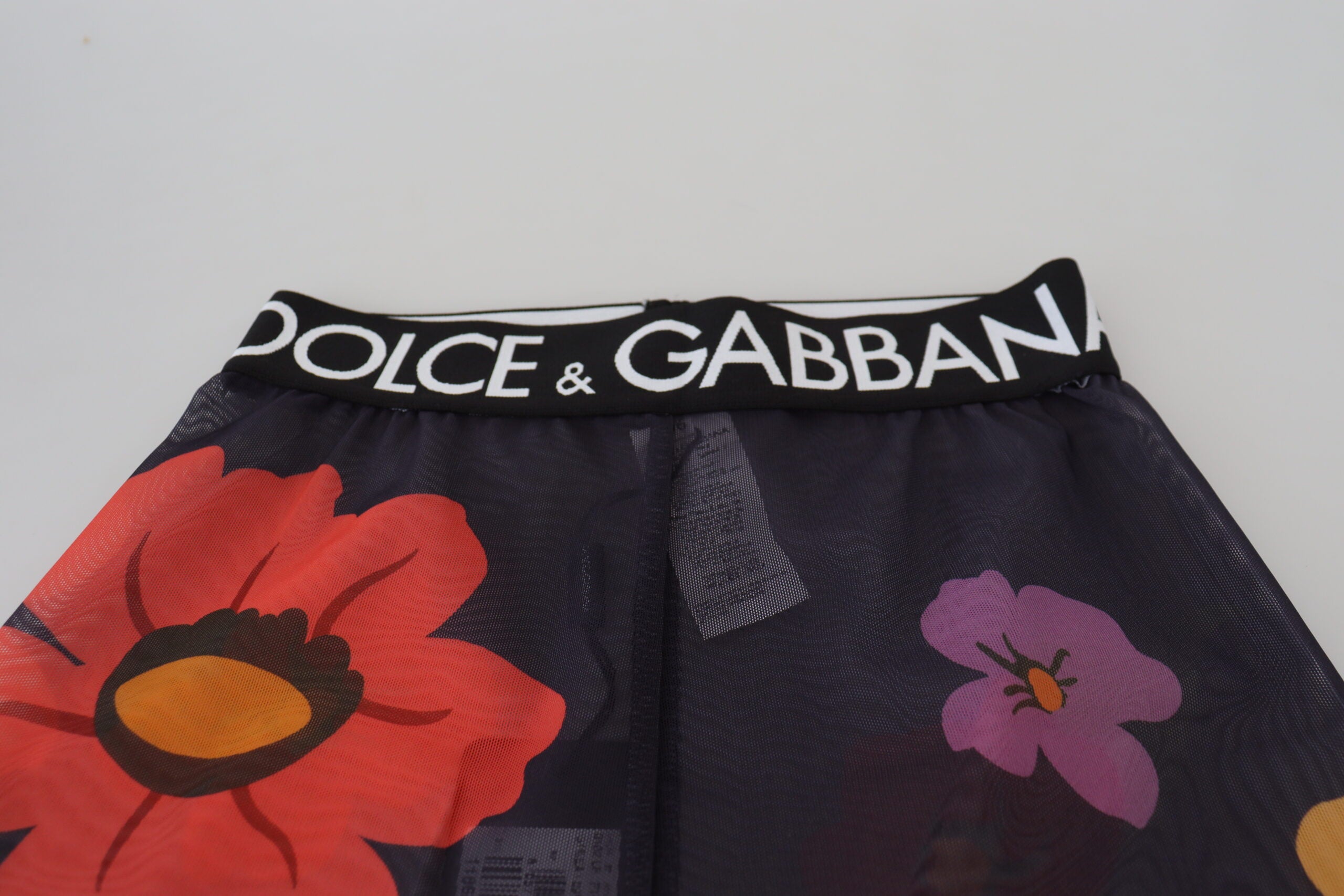 Leggings noires à fleurs Dolce & Gabbana, pantalon extensible à taille élastique, design floral élégant.