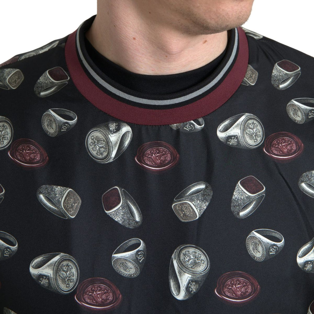 Pull en soie noir Dolce & Gabbana avec motif de bagues, col rond et design élégant.
