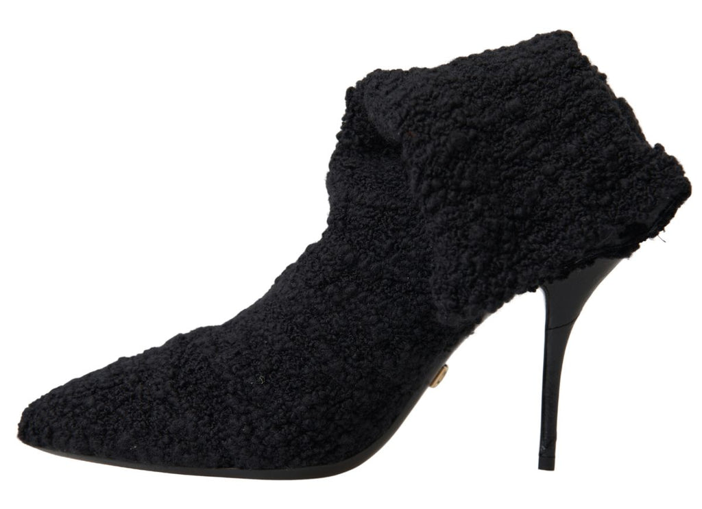Chaussures Dolce & Gabbana, bottines noires à talons stilettos et hauteur mi-mollet, en cuir élégante.
