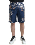 Shorts bermuda en soie à motif floral bleu de Dolce & Gabbana pour homme, avec design élégant et tissu léger.