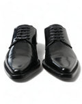 Chaussures plates noires en cuir Dolce & Gabbana avec laçage formel, élégantes et sophistiquées pour femmes.