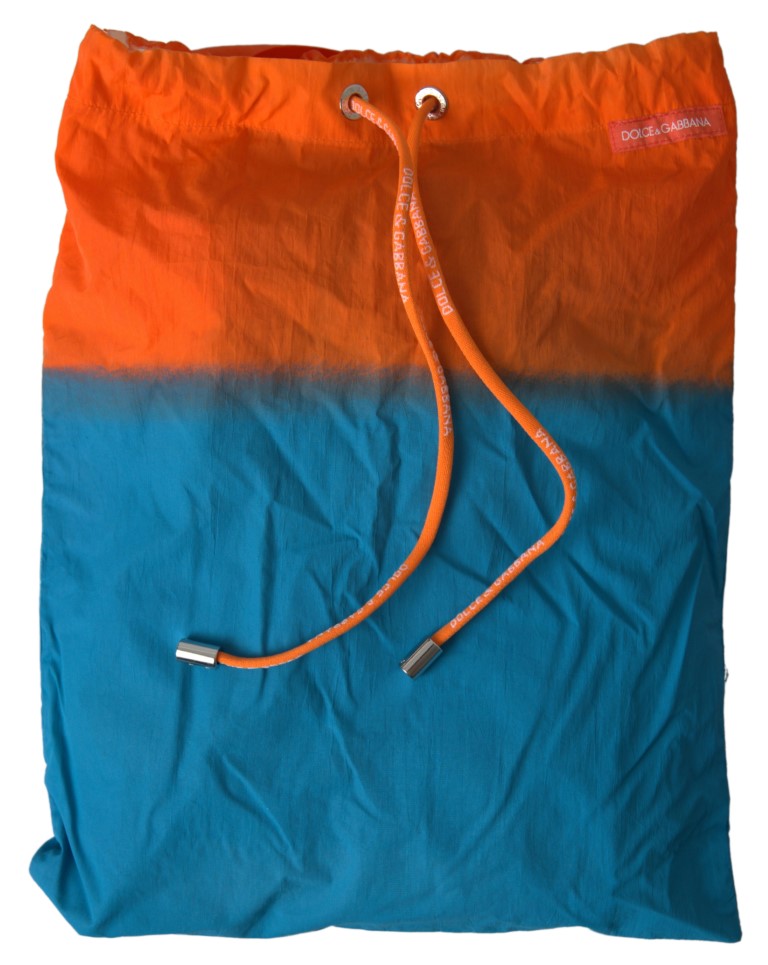 Shorts de bain Dolce & Gabbana à dégradé orange et bleu, maillot de plage pour femmes, style élégant et coloré.