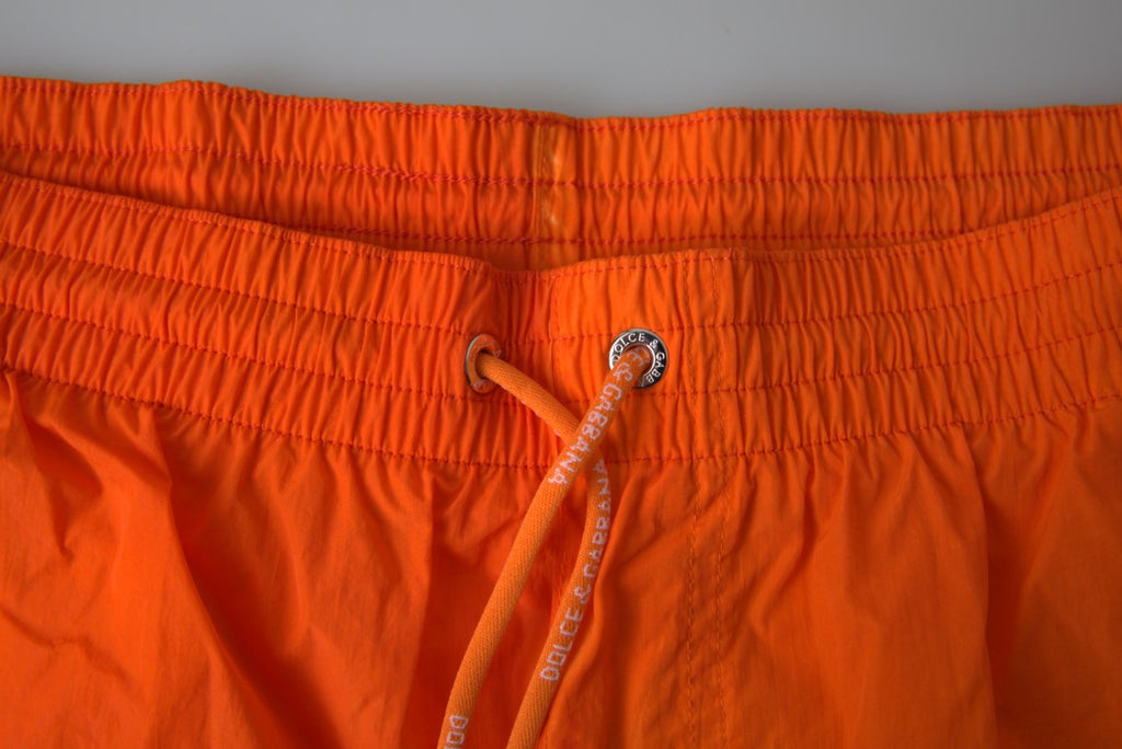 Shorts de bain Dolce & Gabbana à dégradé orange et bleu, maillot de plage pour homme, style élégant et coloré.