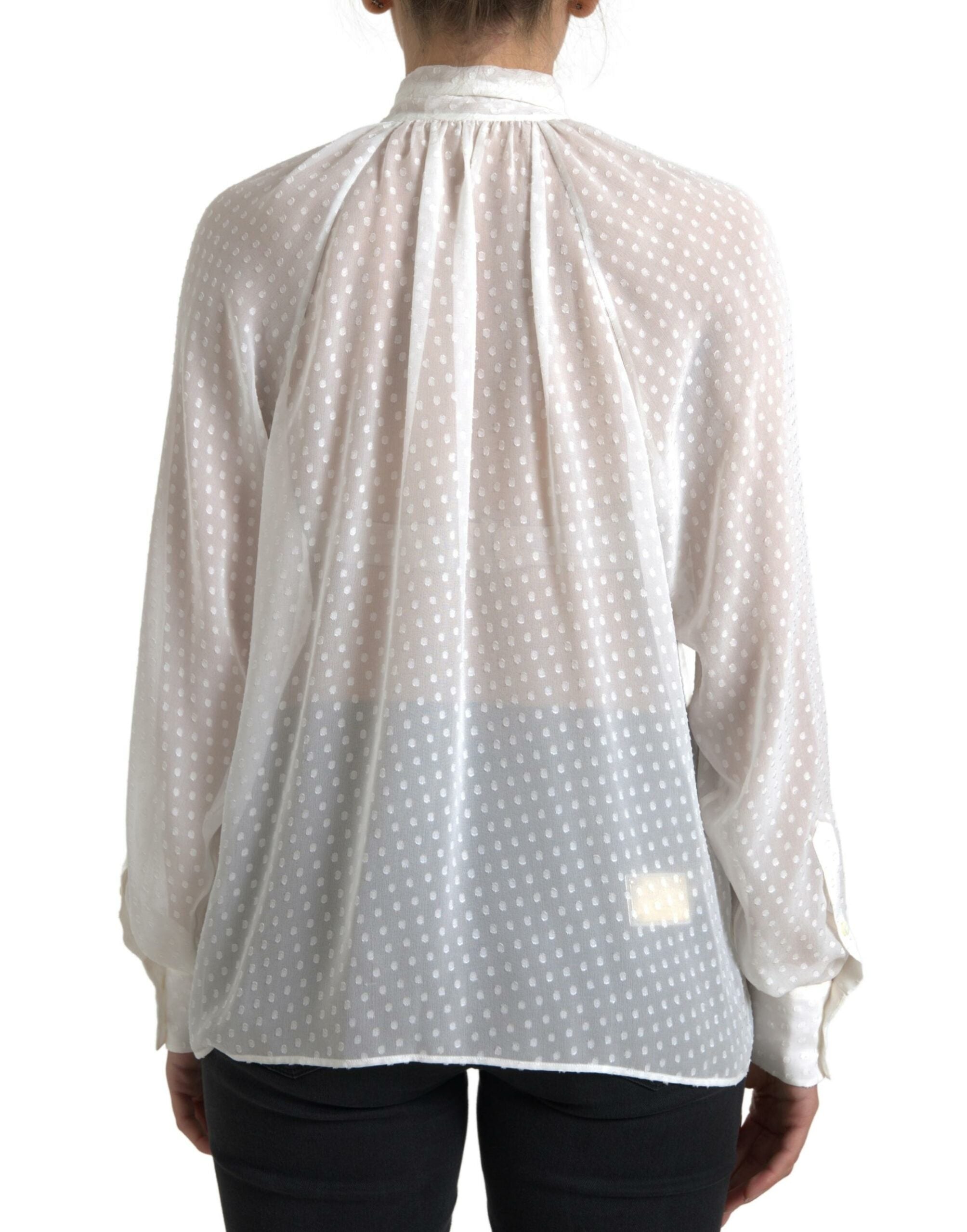 Chemisier en soie blanche Dolce & Gabbana à pois, transparent avec nœud au col, élégant et féminin.