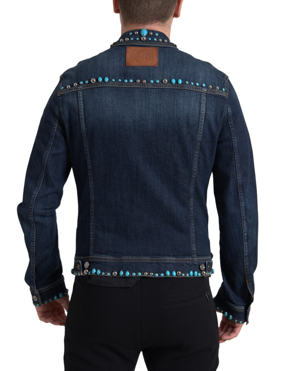 Veste en denim bleu Dolce & Gabbana avec pierres turquoise et détail clous, style élégant et tendance.
