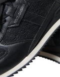 Chaussures sneakers en cuir noir Dolce & Gabbana avec dentelle florale, style élégant et sophistiqué, vue de face.