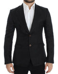 Blazer noir en soie Dolce & Gabbana, coupe ajustée et élégante, portée avec des détails sophistiqués.
