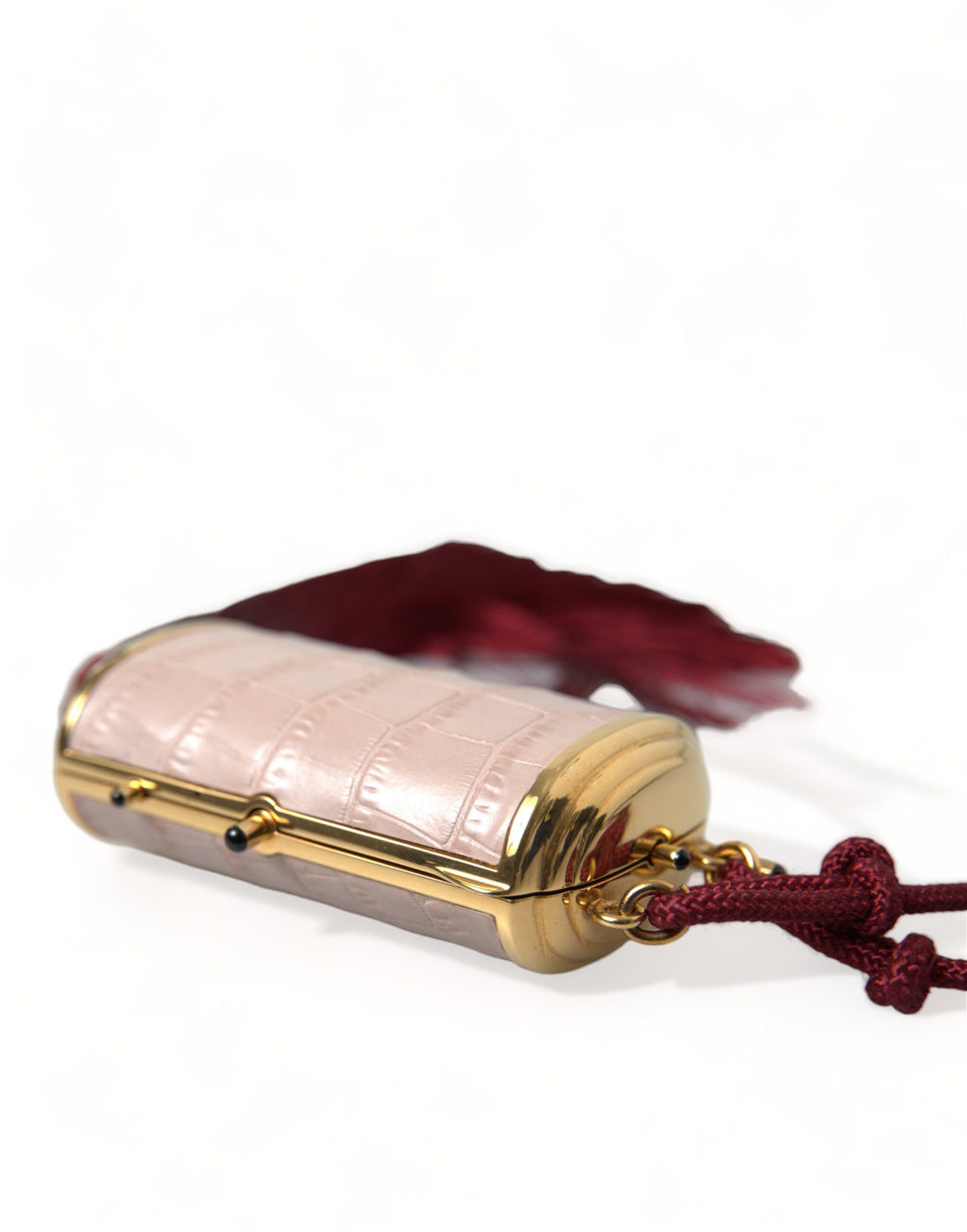 Pochette de maquillage miniature en cuir exotique rose de Dolce & Gabbana avec miroir, tassel et détails élégants.