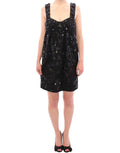 Robe noire Dolce & Gabbana avec motifs floraux en cristaux, élégante et sophistiquée, portée en soirée.