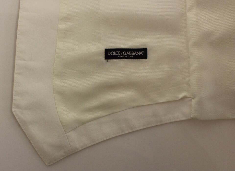 Veste sans manches en coton et soie blanche Dolce & Gabbana, style blazer élégant et chic, portée comme vêtement de dessus.
