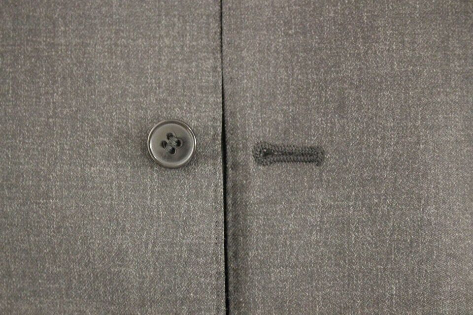Gilet formel en laine gris Dolce & Gabbana porté avec chemise et cravate, détail élégant et sophistiqué.