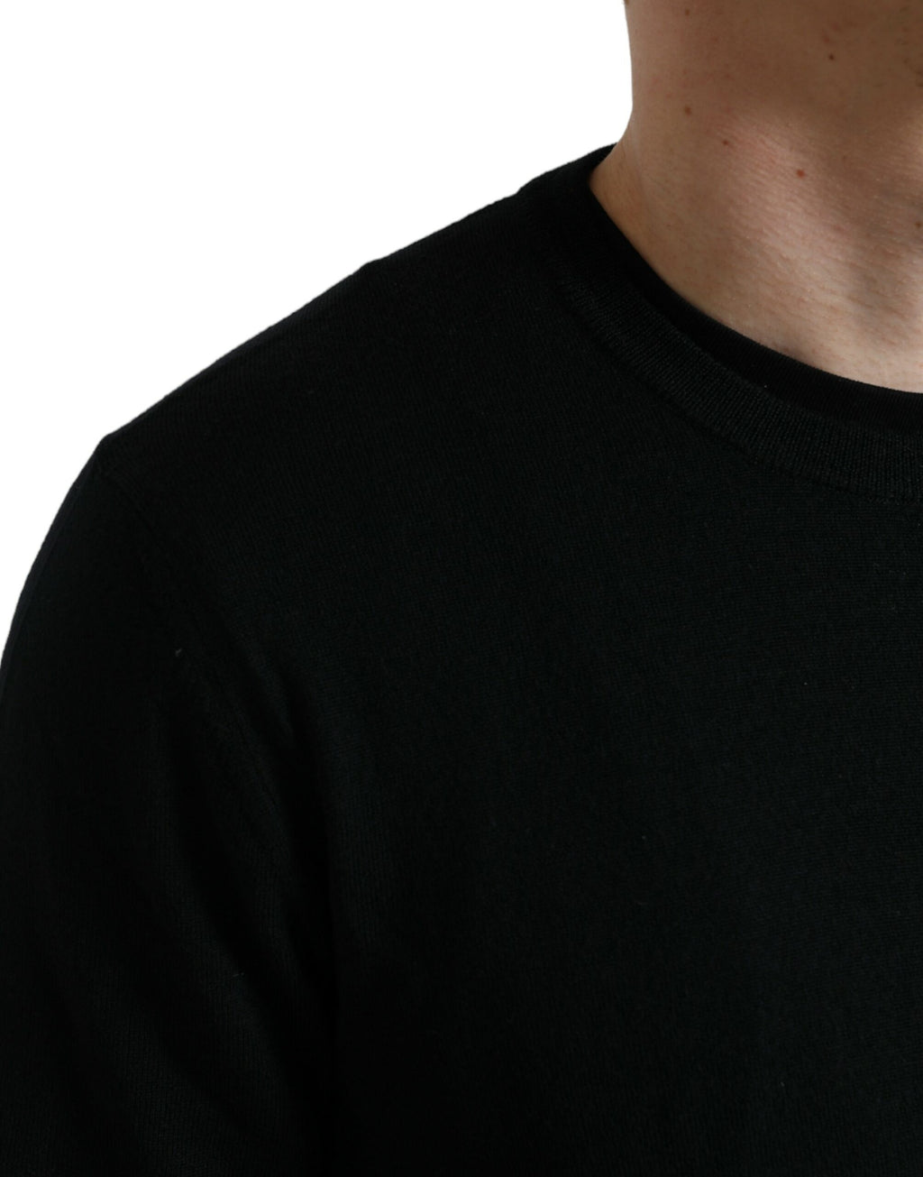 Pull en laine noire Dolce & Gabbana à col rond, vue de face, avec détails de texture visible.