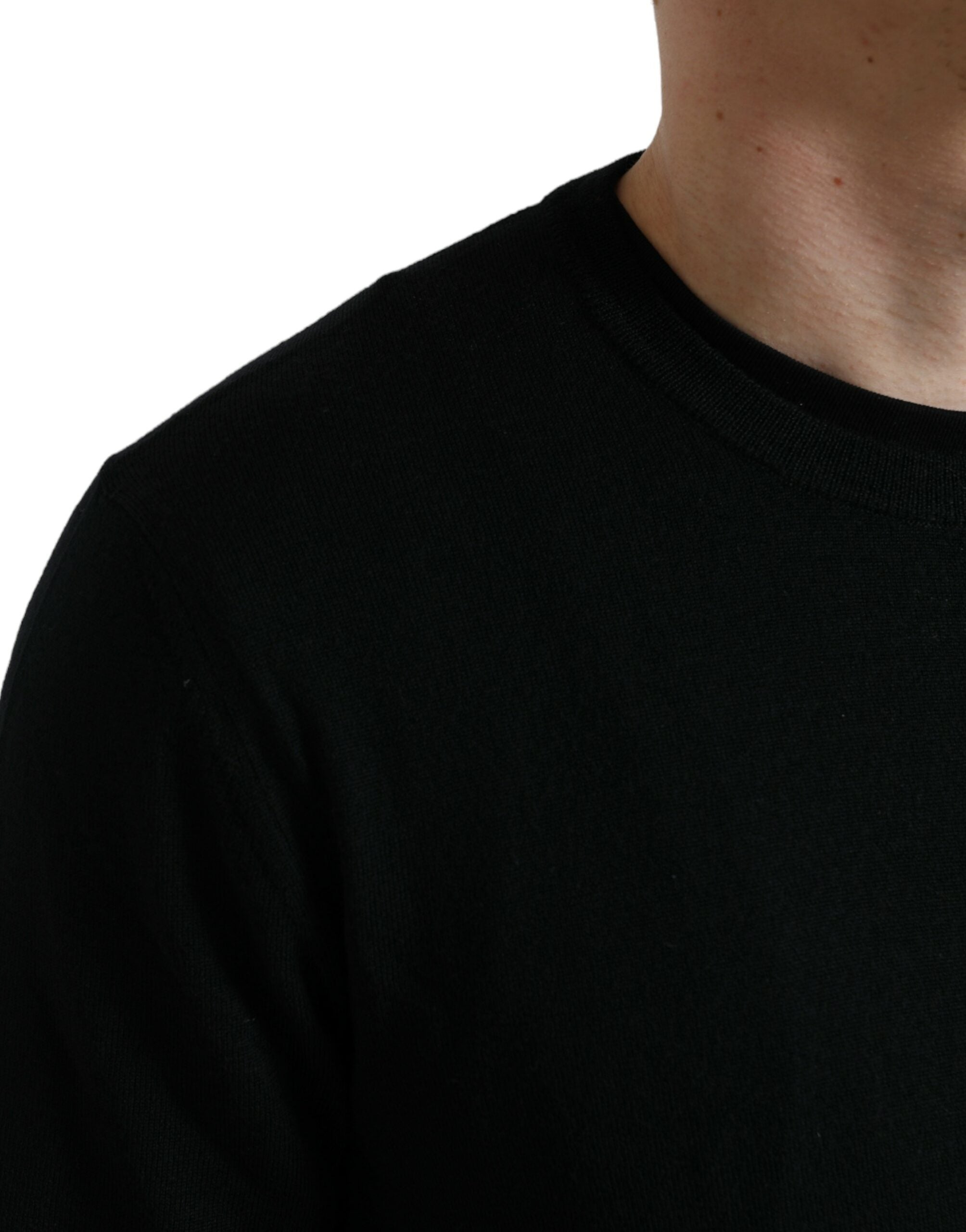 Pull en laine noire Dolce & Gabbana à col rond, vue de face, avec détails de texture visible.