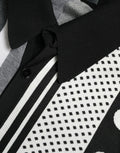Pull Dolce & Gabbana noir et blanc, cardigan polo en laine, style décontracté avec col et manches longues, visible en détail.