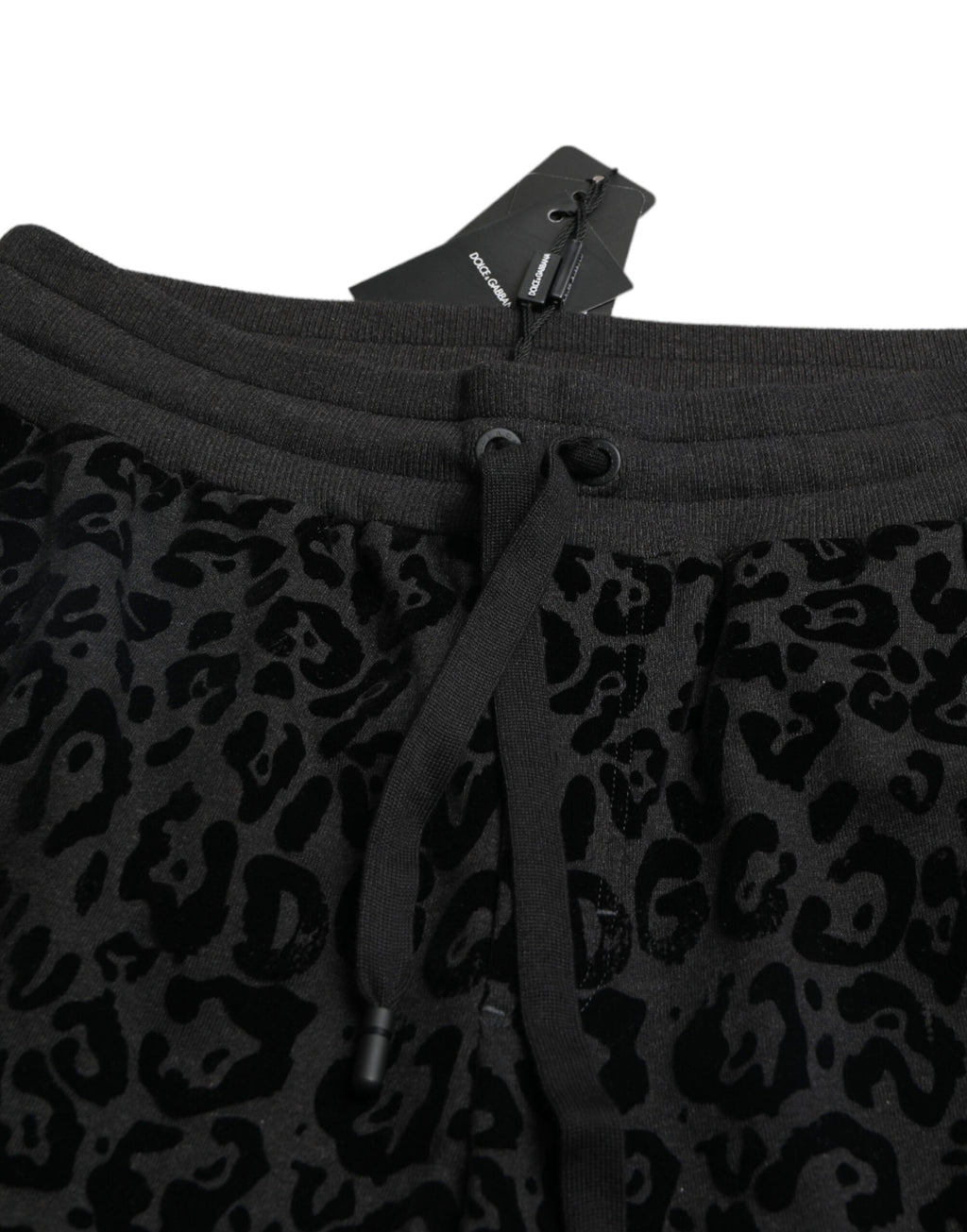 Pantalons joggers slim fit en coton noir à motif léopard Dolce & Gabbana, vue de face avec détails de la couture.