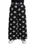 Pantalon large Dolce & Gabbana noir avec logo DG imprimé, style élégant et décontracté, vue de face.