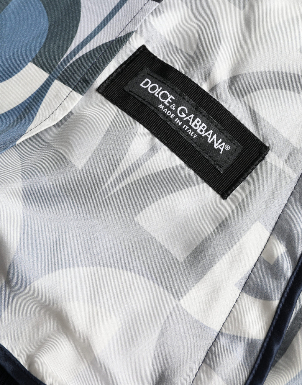 Veste bomber Dolce & Gabbana à logo multicolore, motif imprimé, en tissu léger, avec col et poches sur le devant.