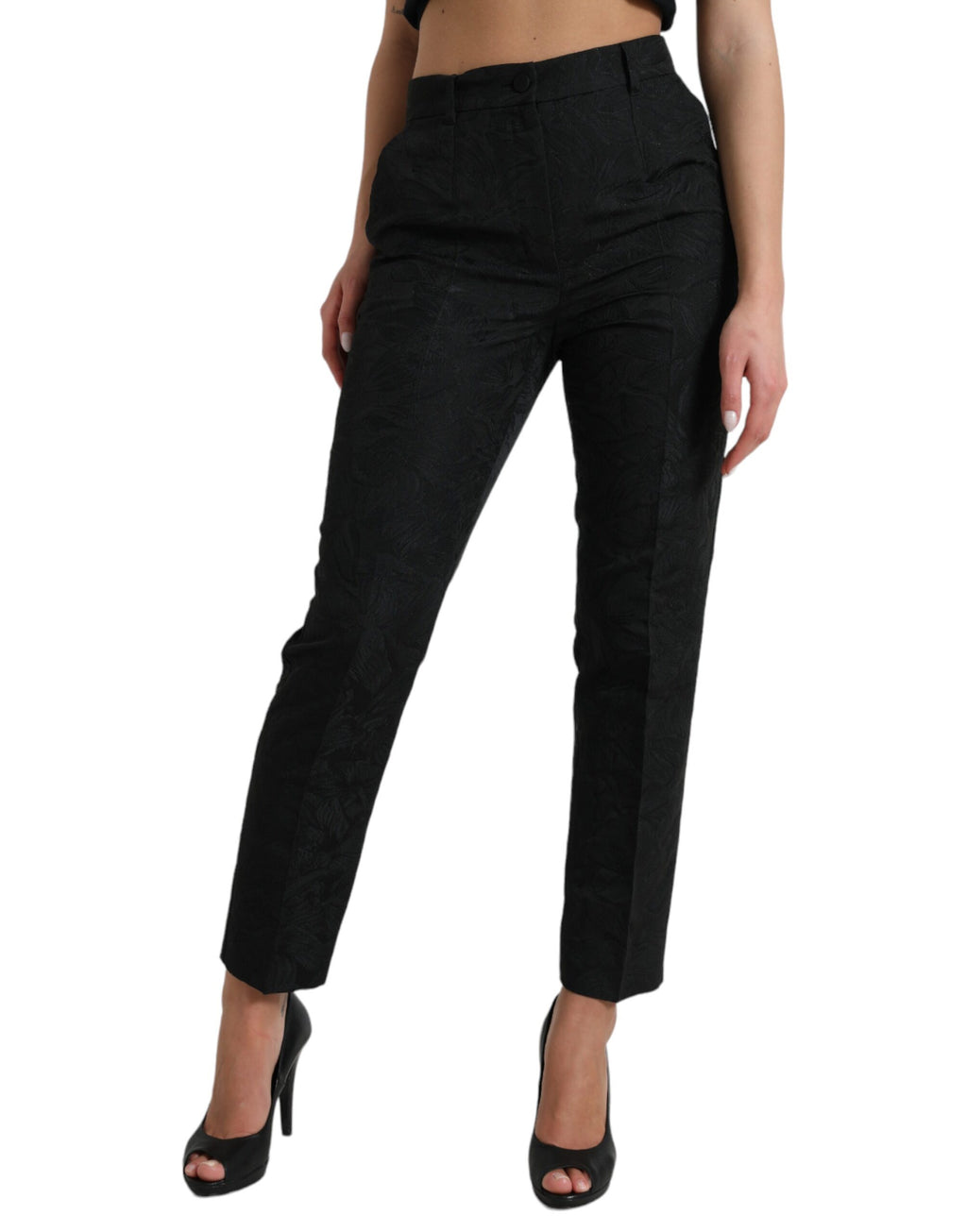 Pantalons noirs en polyester à taille haute et coupe tapered de Dolce & Gabbana, visible en gros plan.