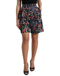 Shorts Dolce & Gabbana à taille haute noire avec motif floral, style hot pants, visibles en détail dans l'image.