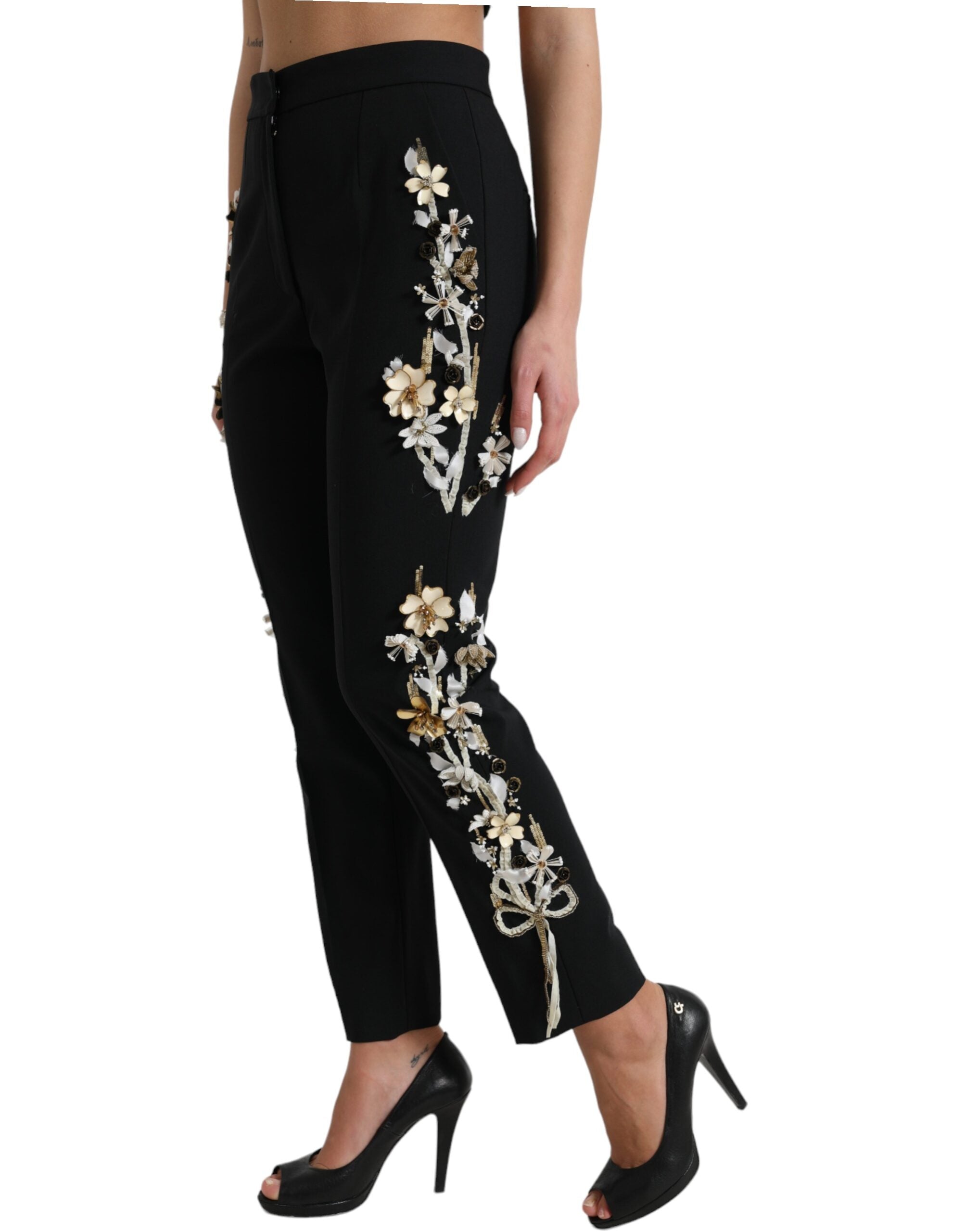 Pantalons Dolce & Gabbana noirs à taille haute avec appliqué floral et coupe tapered, mode élégante pour femmes.