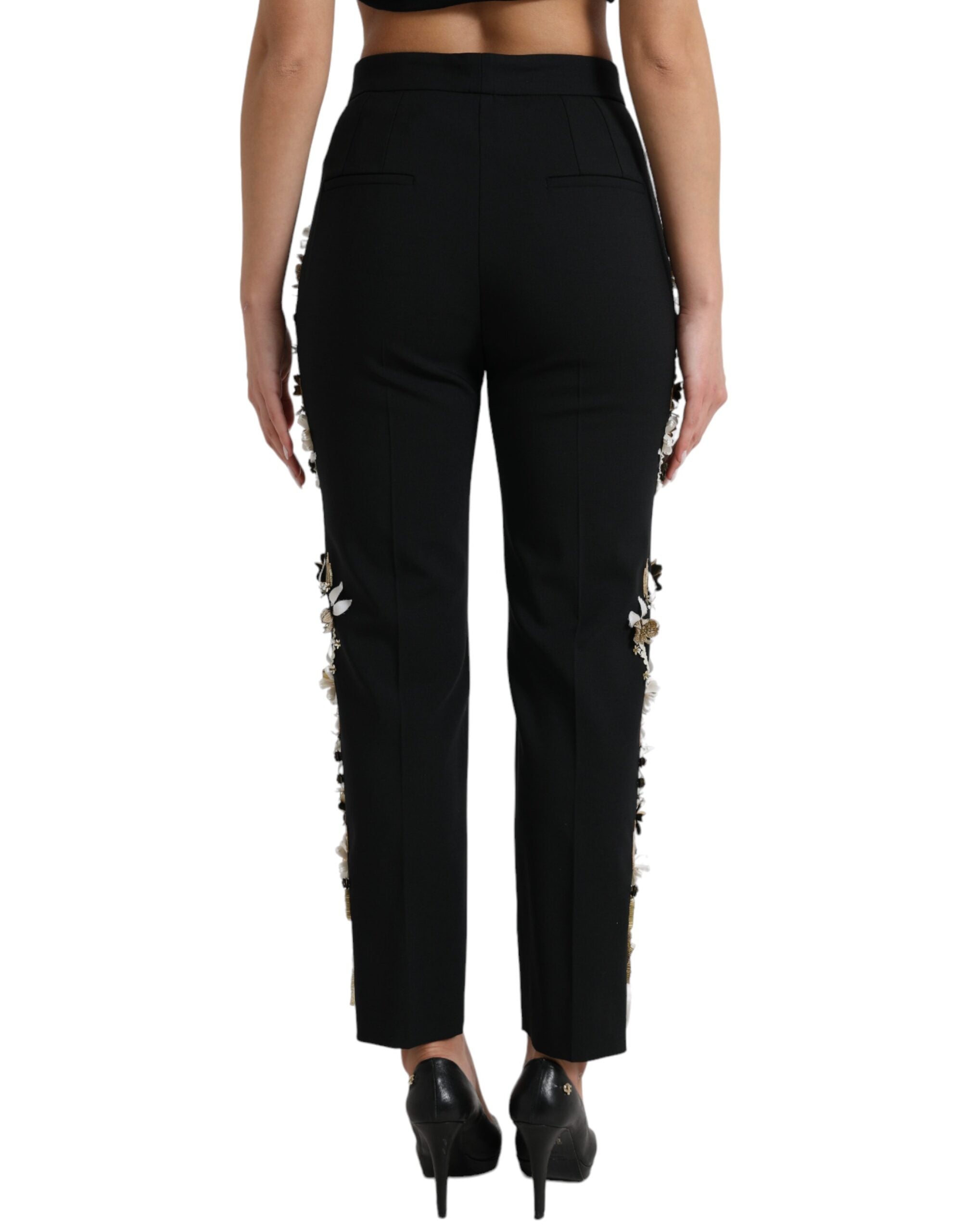 Pantalon noir Dolce & Gabbana à taille haute avec appliqué floral et coupe tapered, élégant et tendance.