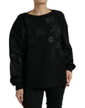 Pull noir Dolce & Gabbana en laine avec logo floral appliqué visible sur la poitrine.