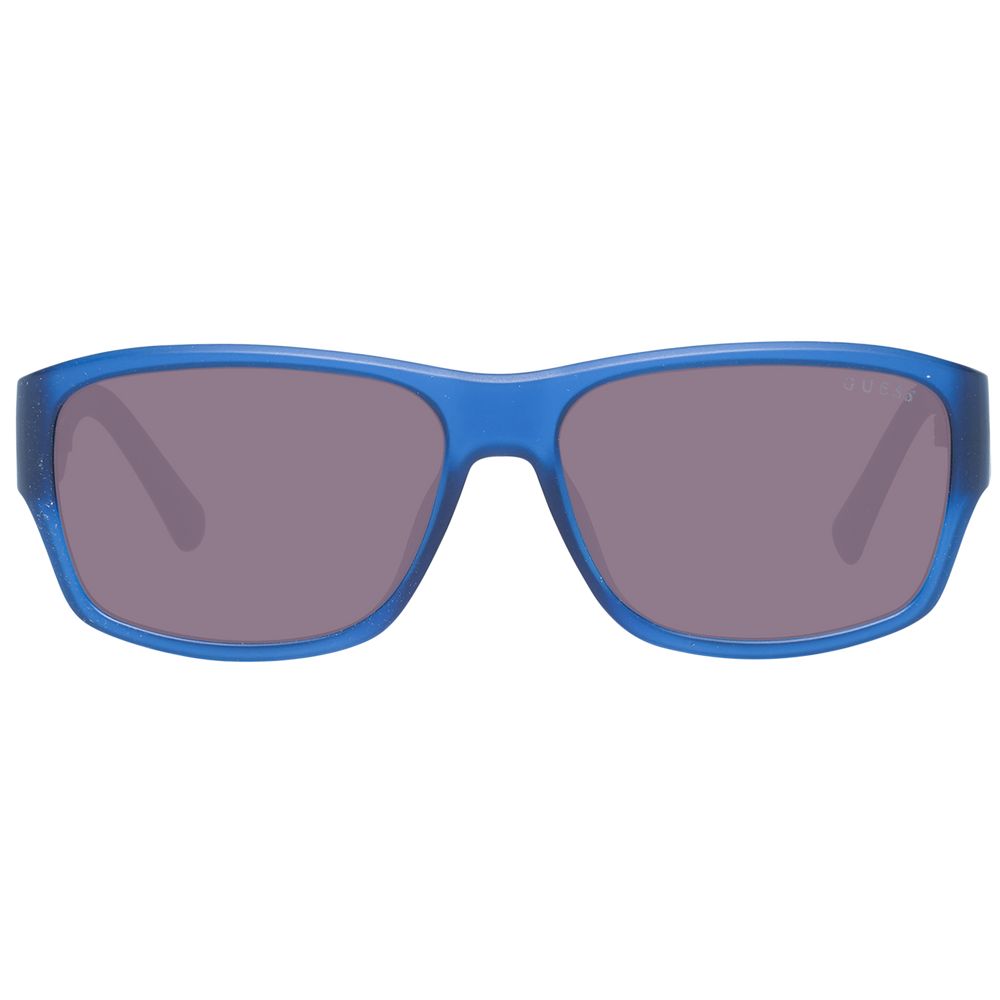 Lunettes de soleil en plastique bleues Guess avec monture ronde et branches épaisses, style moderne et tendance pour l'été.