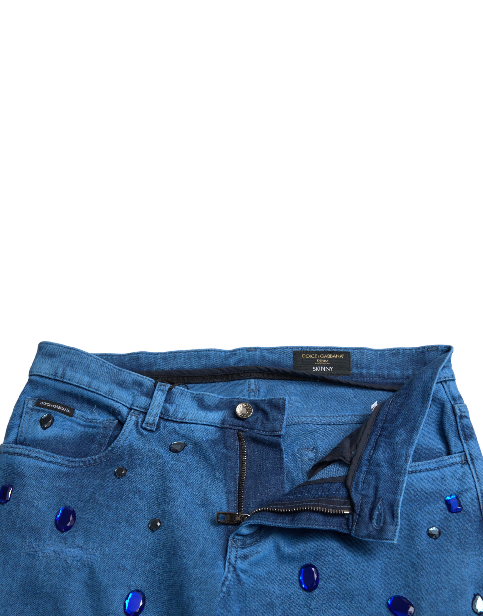 Jeans skinny en denim bleu Dolce & Gabbana ornés de cristaux brillants, mode élégante et sophistiquée.