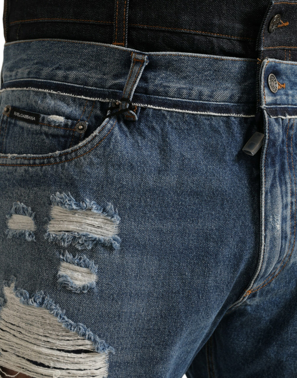 Jeans en denim pour homme Dolce & Gabbana, coton bleu tacheté, style déchiré, mode élégante et décontractée.
