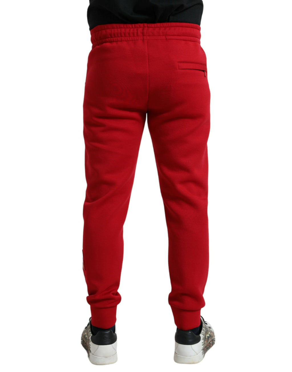 Pantalons slim jogger en coton mélangé rouge de la marque Dolce & Gabbana, vue de face avec détails de couture.
