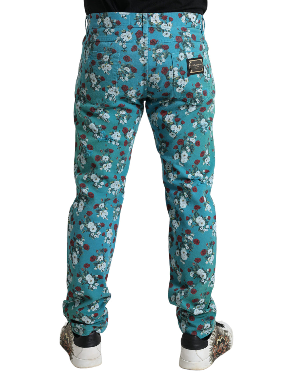 Pantalon skinny en denim coton avec imprimé floral bleu de Dolce & Gabbana, vue de face sur fond blanc.