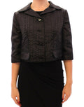 Boléro court noir Dolce & Gabbana, veste shrug élégante en tissu léger, porté sur un haut chic.