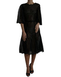 Robe mi-longue en dentelle florale noire de Dolce & Gabbana, style évasé et transparente, pour une allure élégante et sophistiquée.