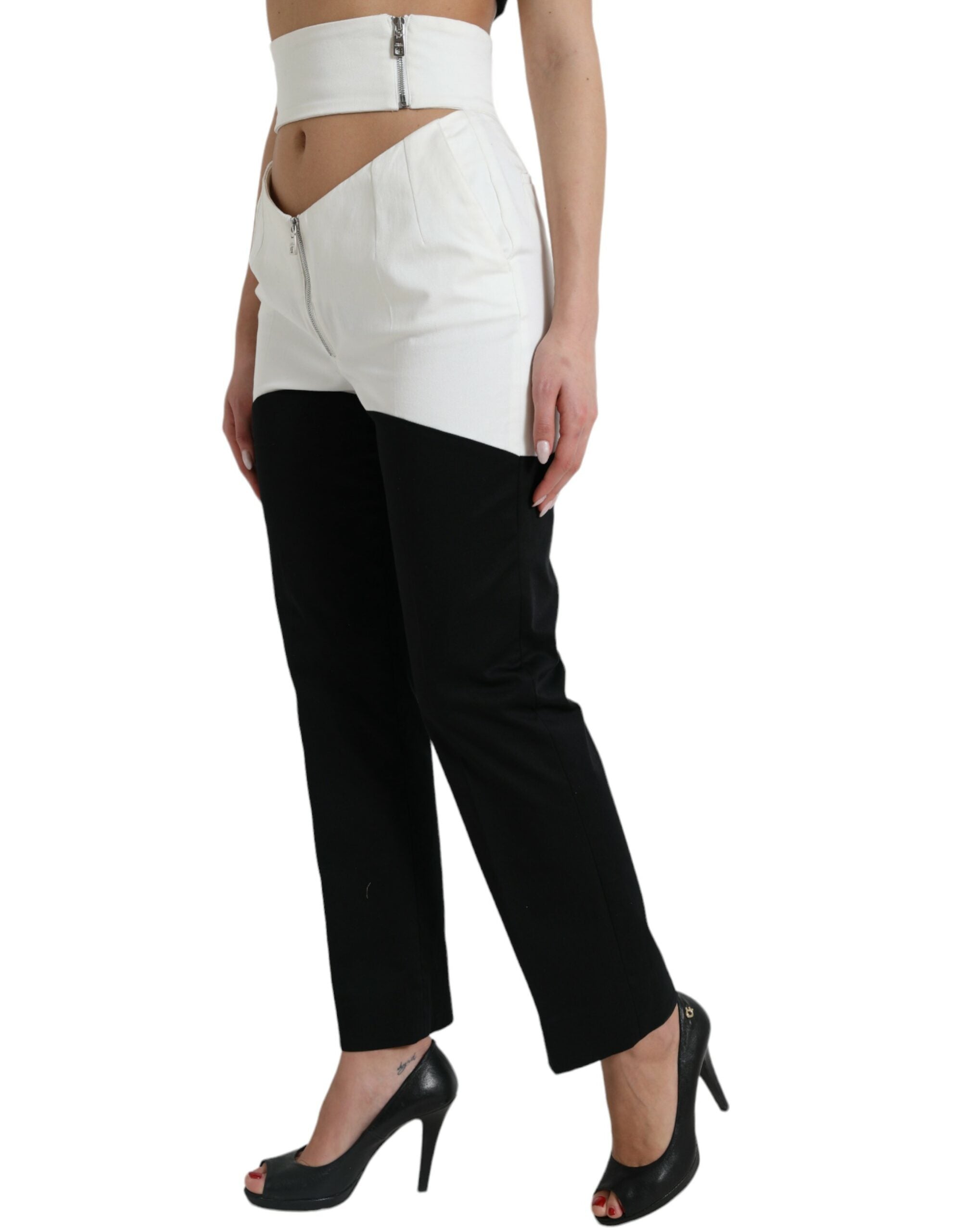 Pantalons tapered en coton noir et blanc Dolce & Gabbana avec découpes à la taille, style élégant et moderne.