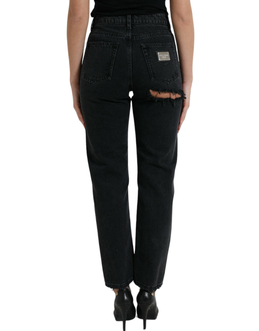 Jeans en denim noir Dolce & Gabbana, taille haute, déchirés, style décontracté, visible en gros plan.