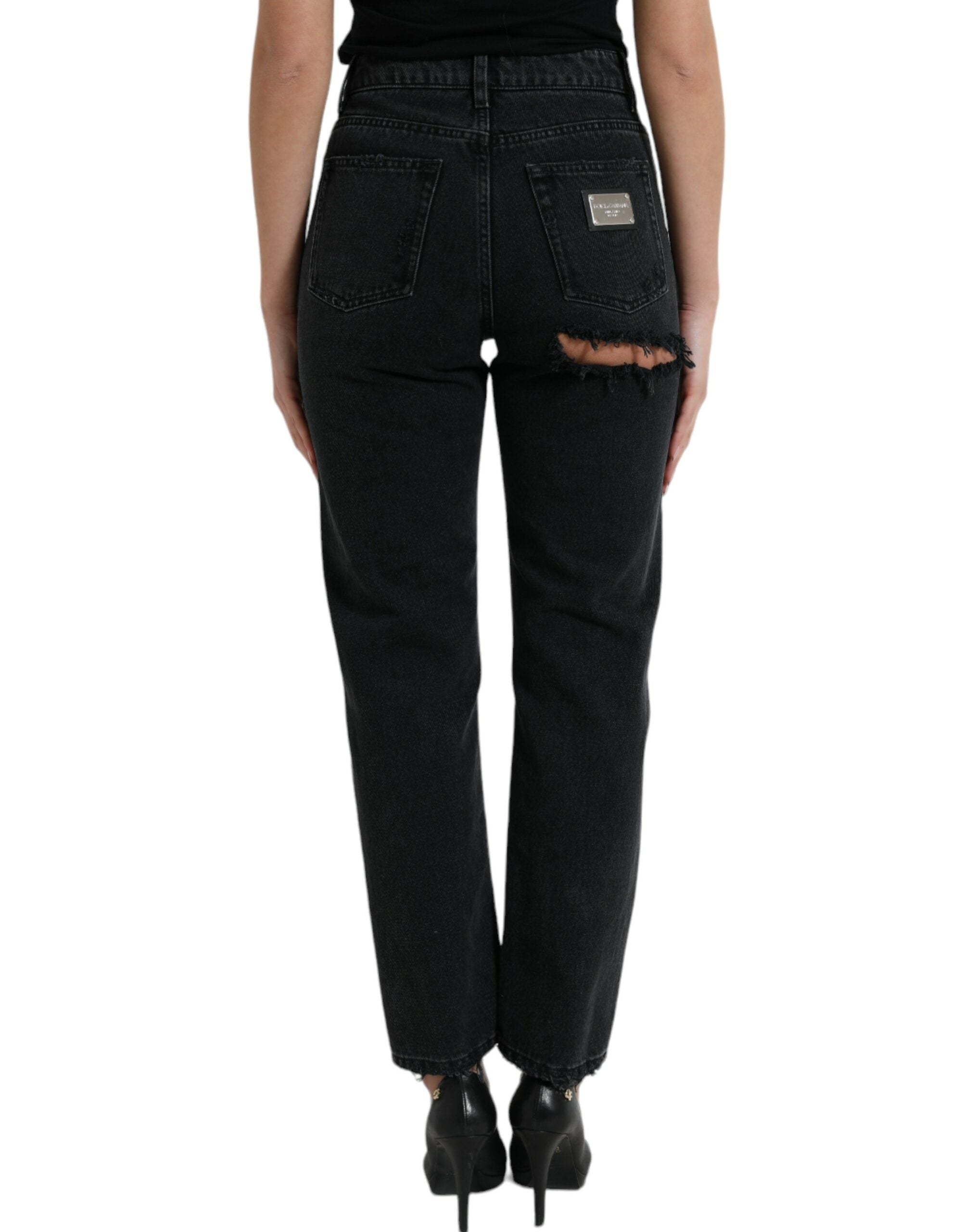 Jeans en denim noir Dolce & Gabbana, taille haute, déchirés, style décontracté, visible en gros plan.
