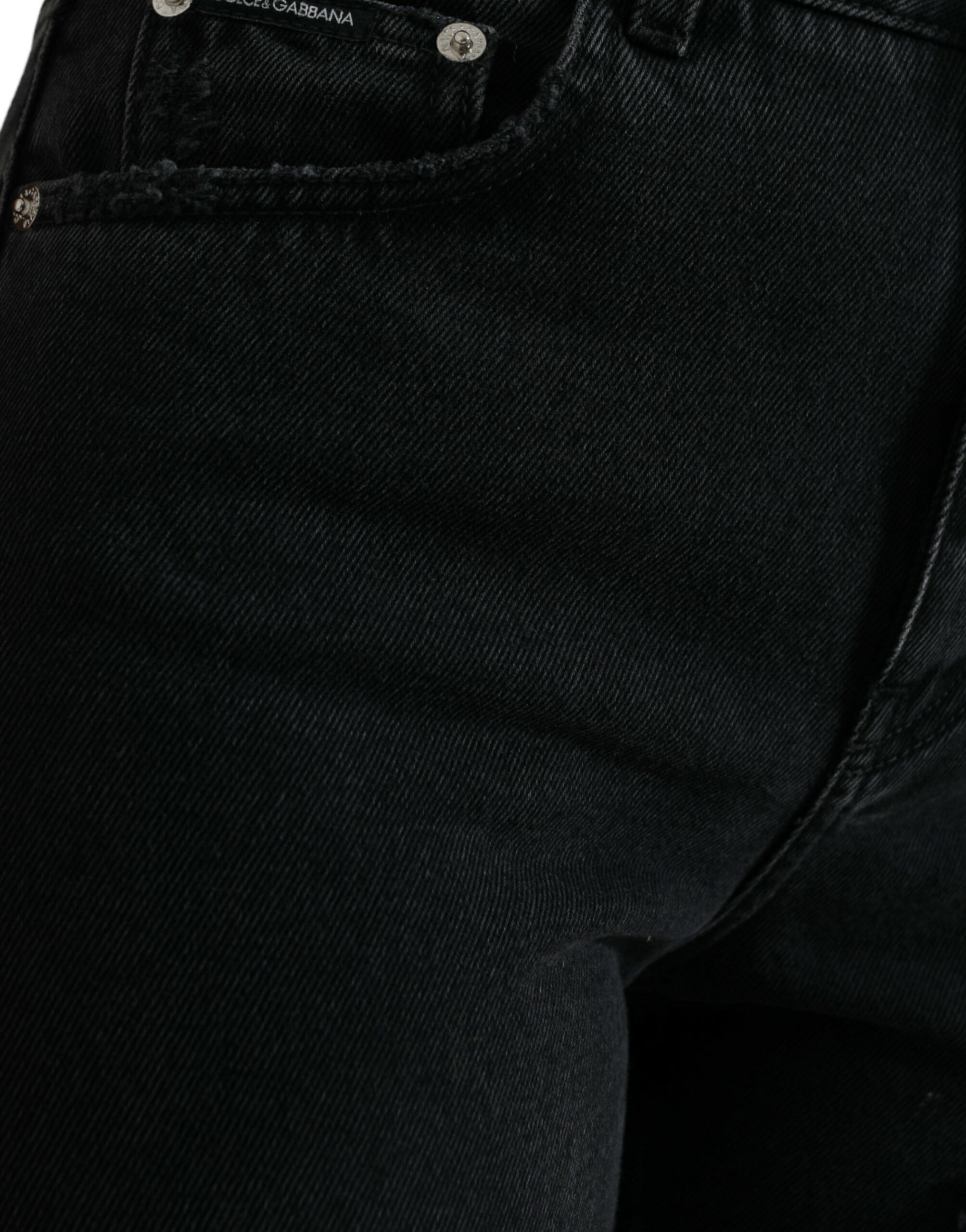Jeans en denim noir Dolce & Gabbana, taille haute, déchirés et usés, style tendance et moderne.