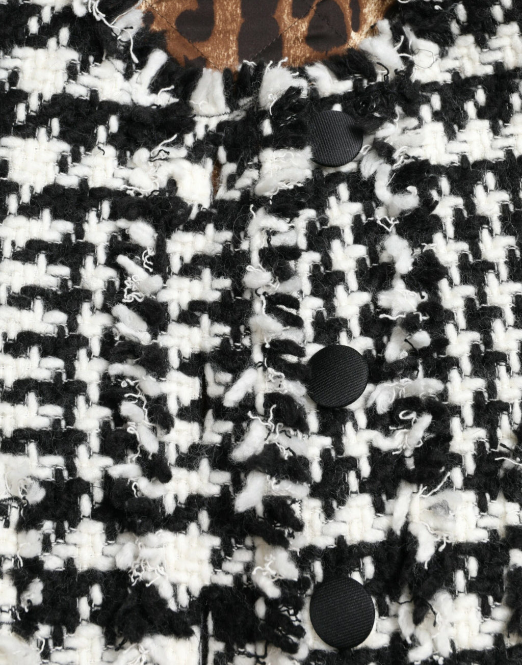 Veste trench Dolce & Gabbana en houndstooth noir et blanc, coupe classique avec col et manches longues.