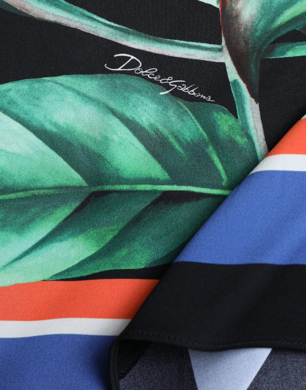 Jupe midi noire Dolce & Gabbana Strelitzia à taille haute et ceinture portefeuille, en tissu fluide.